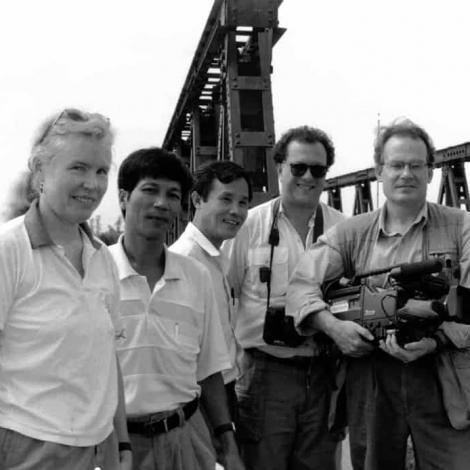 <span style="color: #000000 !important;font-size: 14pt">Janet Gardner and film crew stand on the bridge that forms the DMZ (Demilitarized Zone) dividing North and South Vietnam.</span>