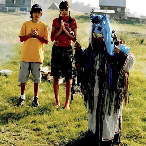 <span style="color: #000000 !important;font-size: 14pt">Irina (center) with her son Ruslan (left,) and a Shaman perform a ritual in Buryatia. Buryiats practice Buddhism and Shamanism simultaneously.</span>